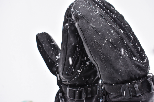 close up image of cozy magne mitt summitt with snow flakes falling