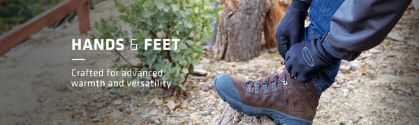 Hands & Feet text on left with hands wearing Seirus gloves tying boot laces on a log in the outdoors