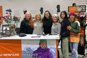 photo of 6 women standing and smiling behind the Seirus trade show booth