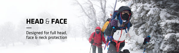 Snowy outdoors with two people hiking with cross country skis and a bunch of snow gear on