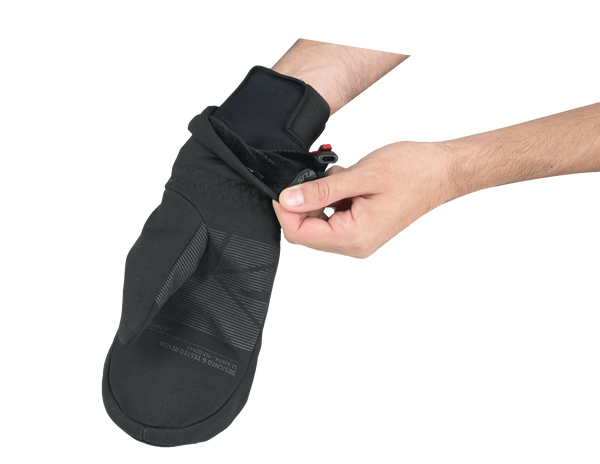 Black mitt being adjusted over black inner glove on a white background